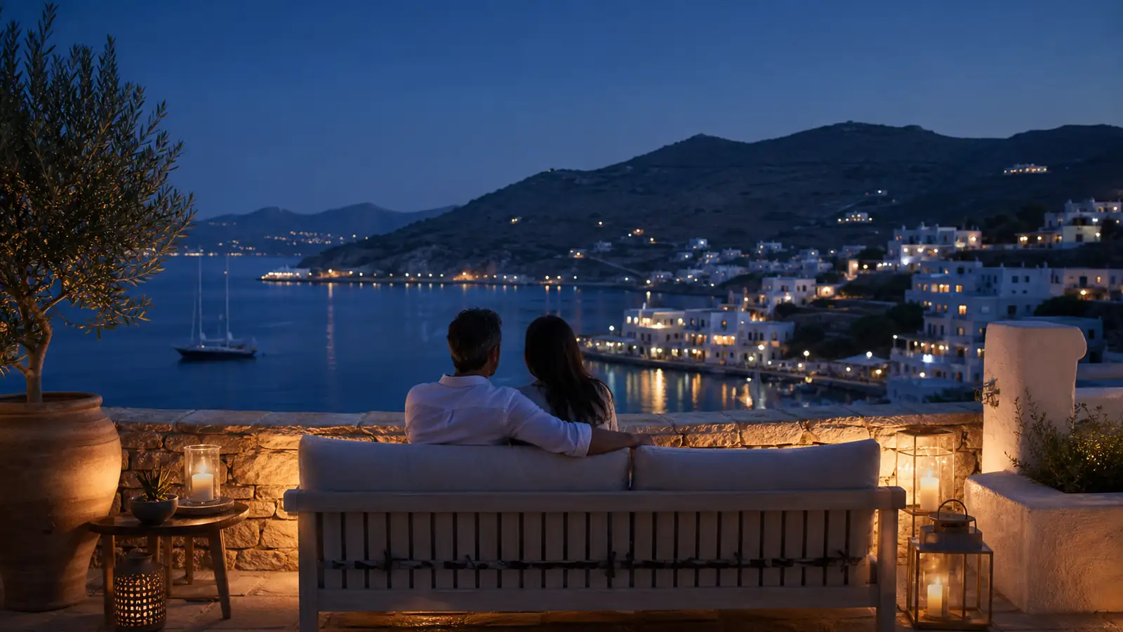 Private Greek villa terrace overlooking a quiet harbour at blue hour
